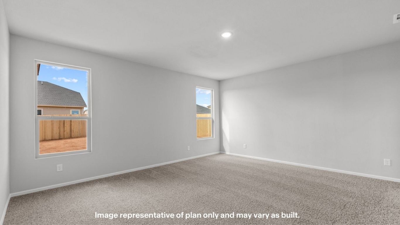 Primary bedroom with plush carpet floors and double light allowing windows