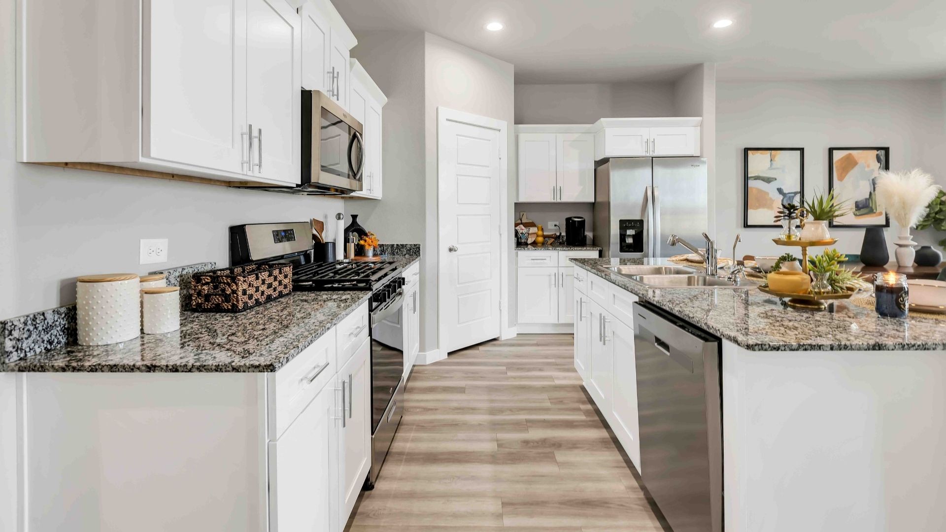 Modern open concept kitchen with stainless steel appliances and elevated finishes