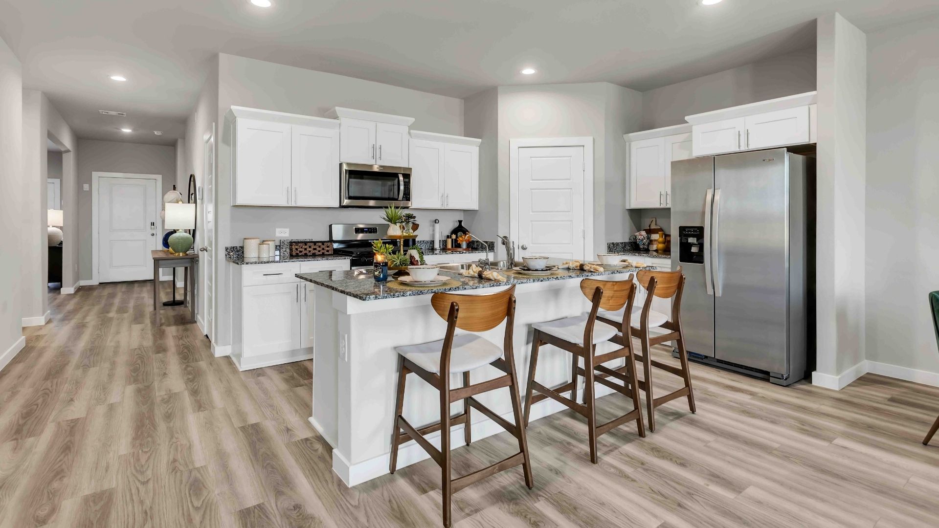 Interior white kitchen with spacious kitchen island and counter prep space
