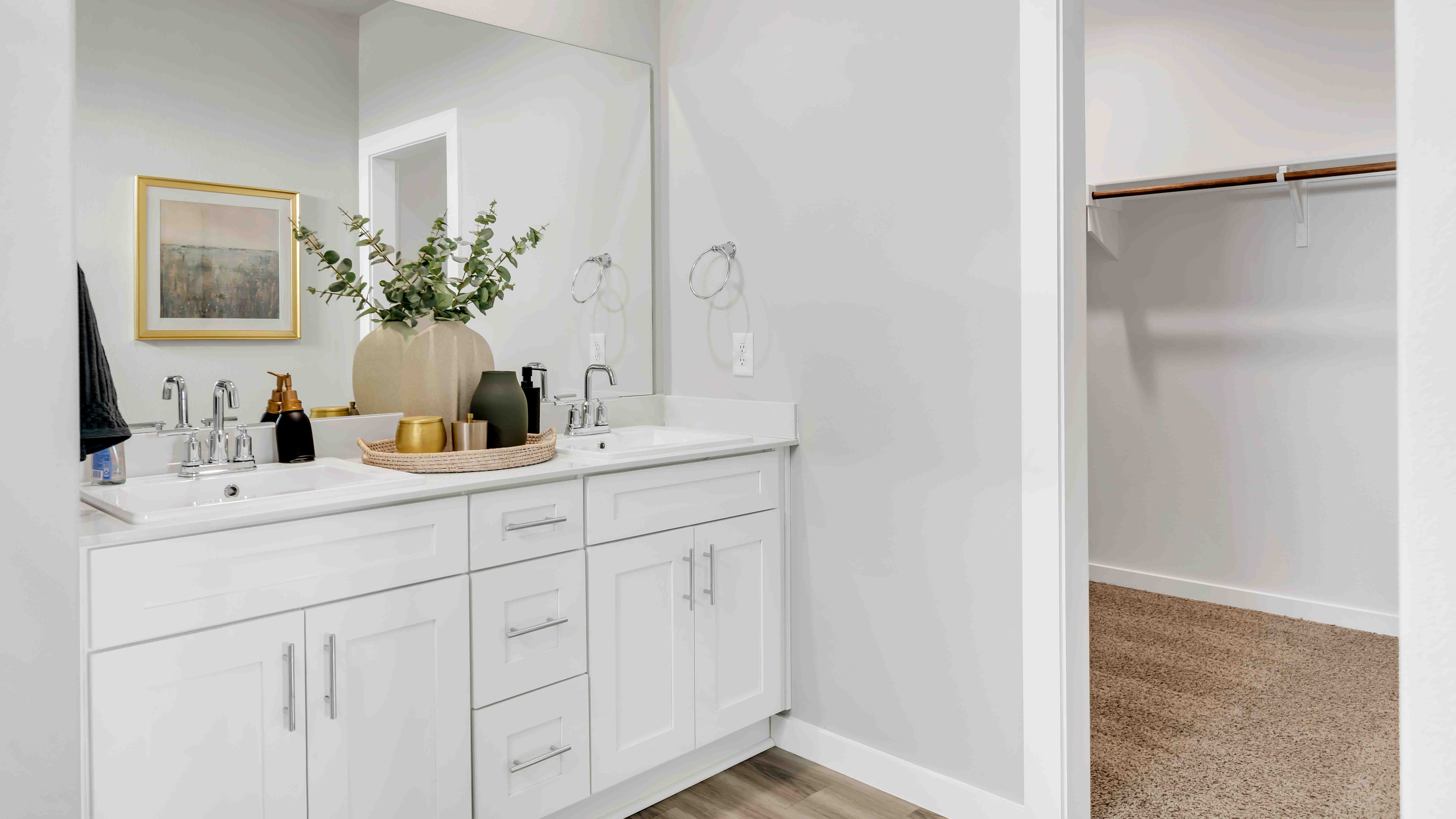 Primary bathroom ensuite attached to primary bedroom with built in vanity and double sinks