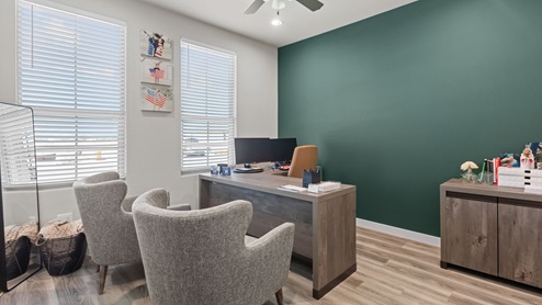 Front bedroom with colorful accent wall and ample natural sunlight