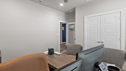 Bedroom three with double closet doors and natural sunlight