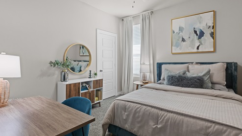 Modern guest bedroom with colorful blue and gold accent colors