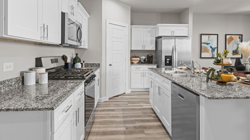 Modern open concept kitchen with stainless steel appliances and gorgeous countertops
