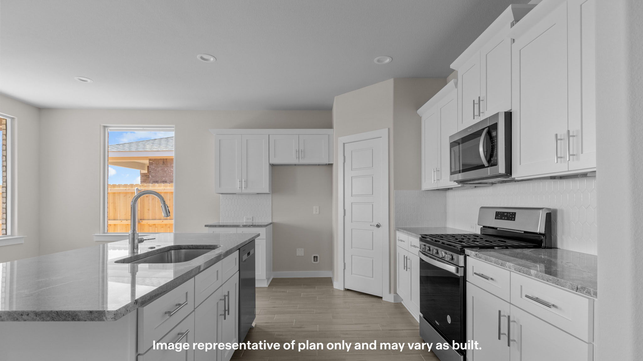 Open concept kitchen with stainless steel appliances, shaker style cabinets, and elevated finishes