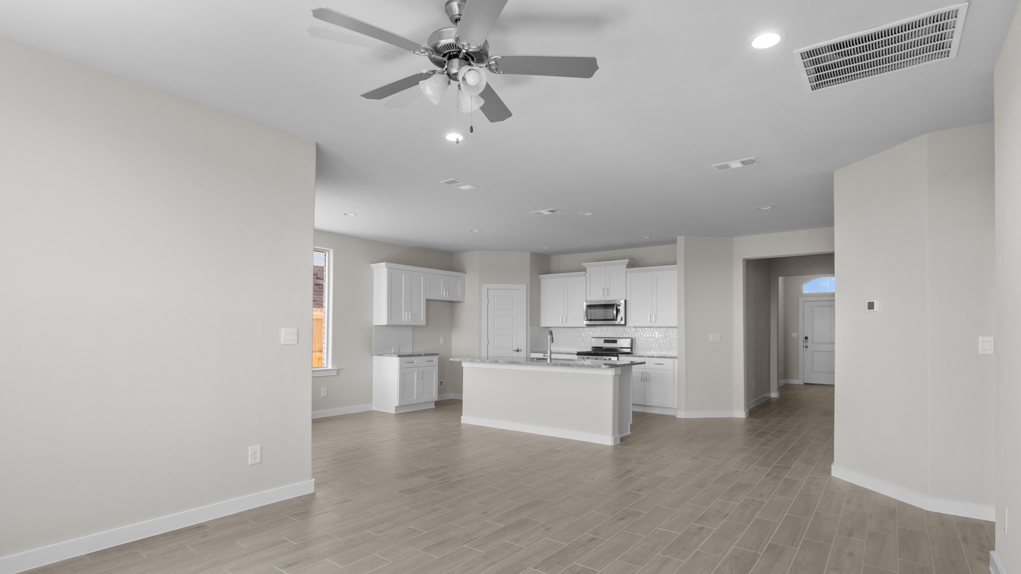 Spacious open concept family, living, and dining area with kitchen overlooking