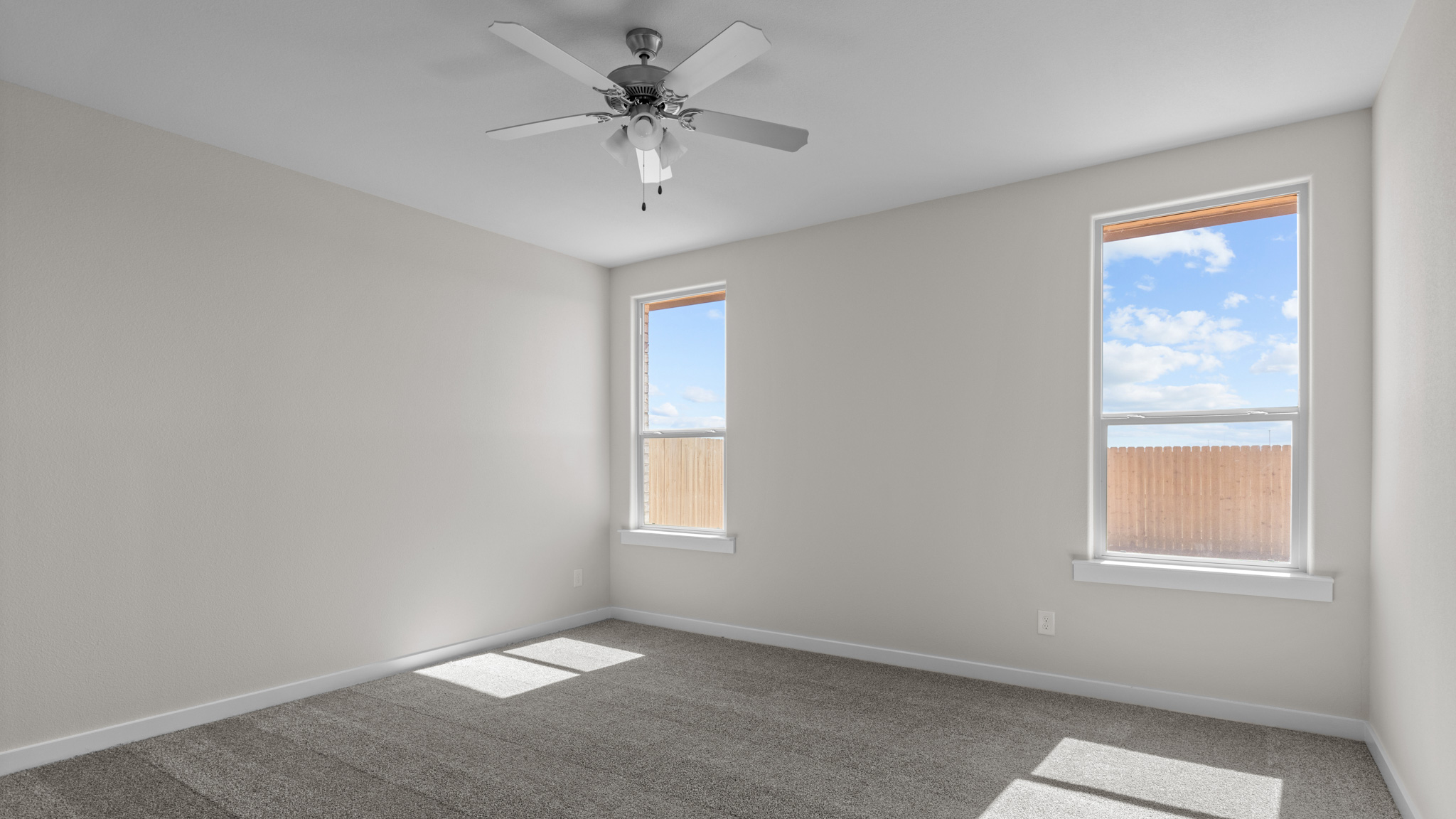 Primary bedroom with natural light allowing windows