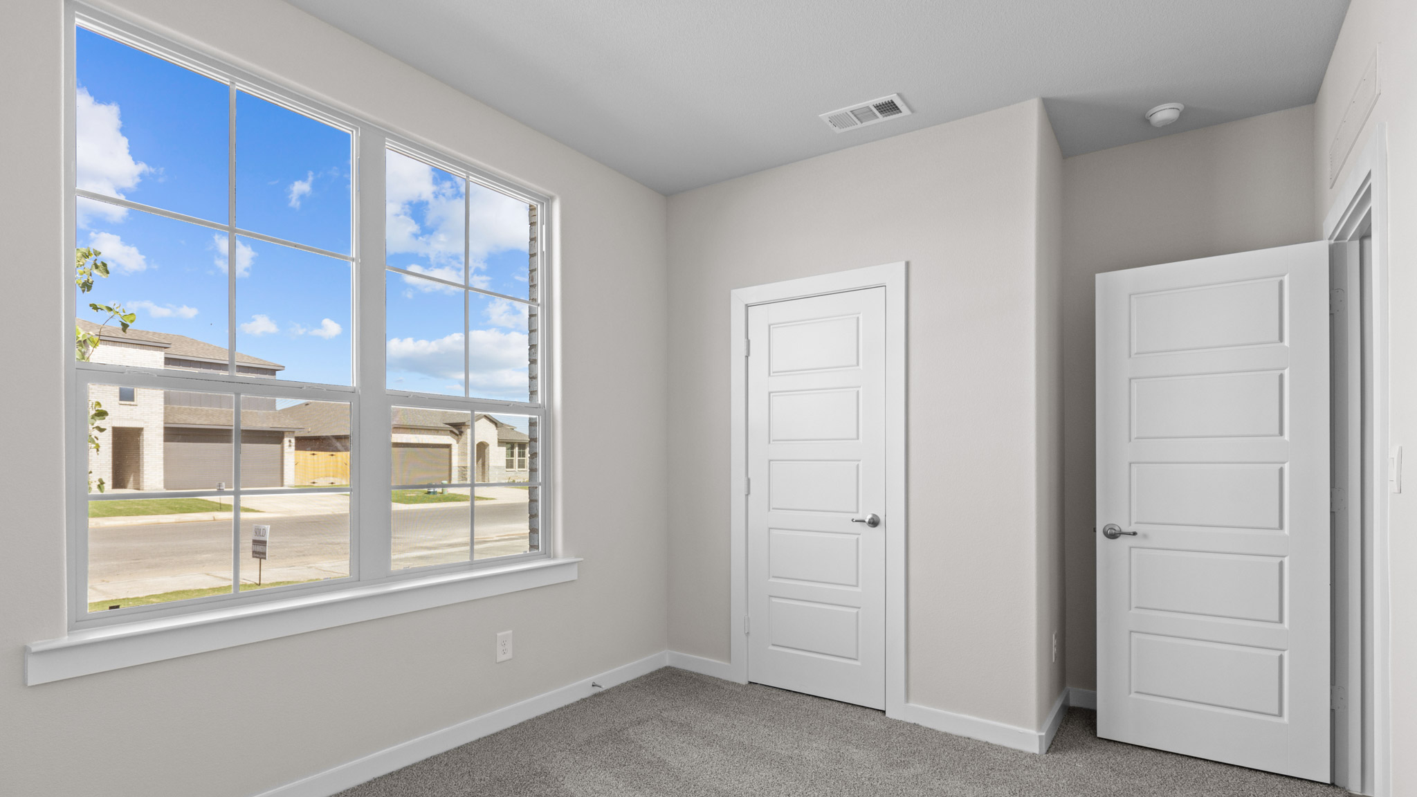 Spacious front guest bedroom with plenty of natural light