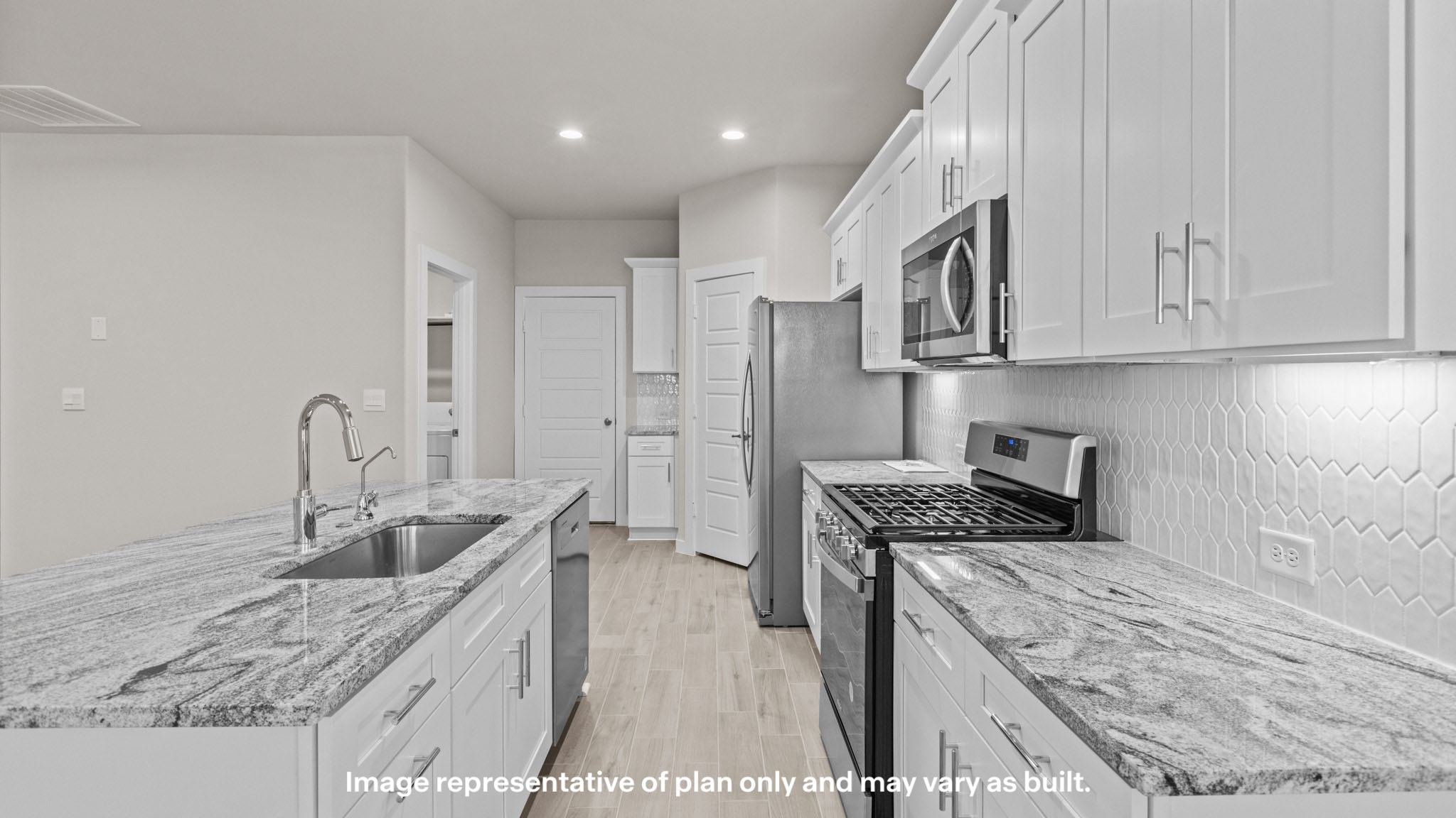 Open concept kitchen with stainless steel appliances, shaker style cabinets, and elevated finishes
