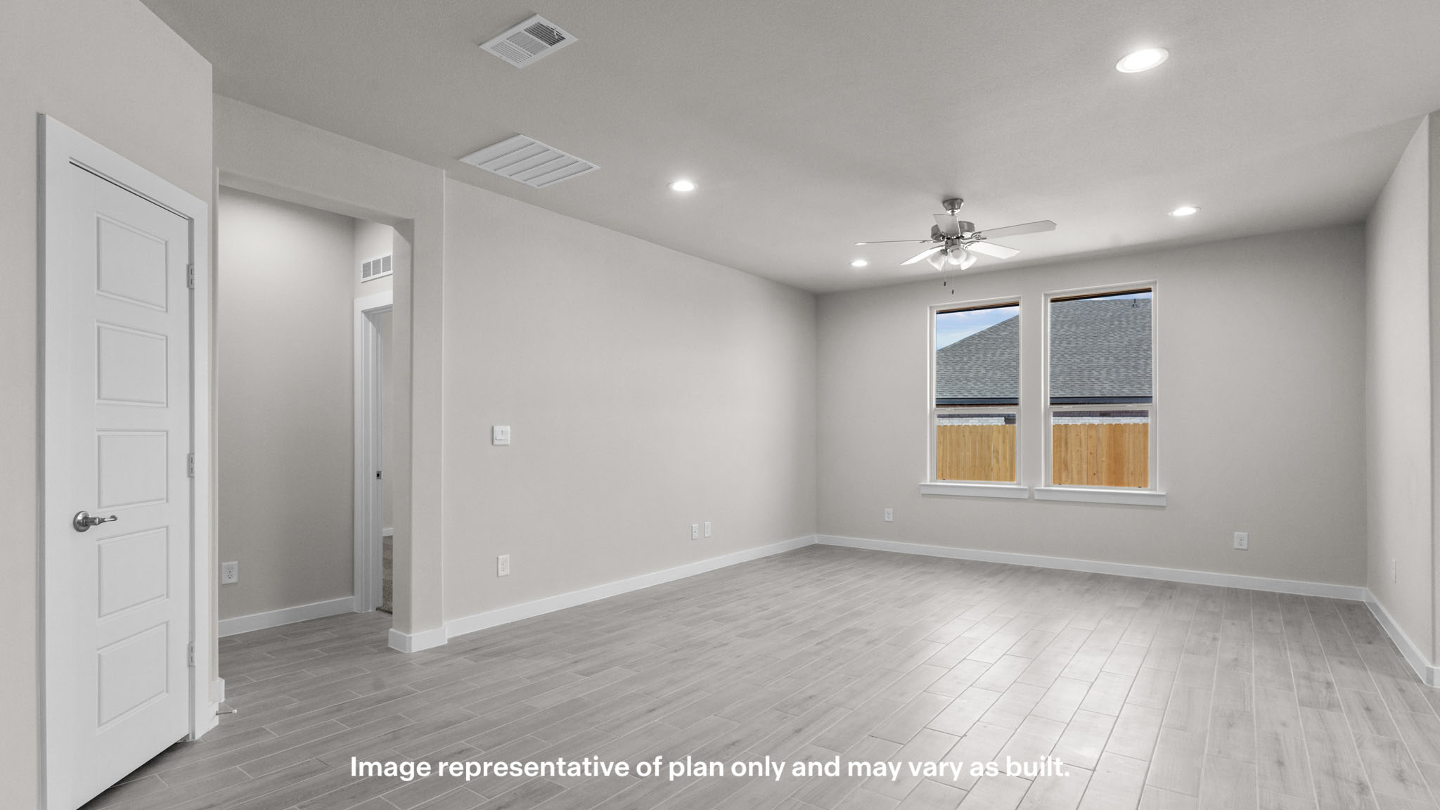 Spacious living and family room space with light allowing windows