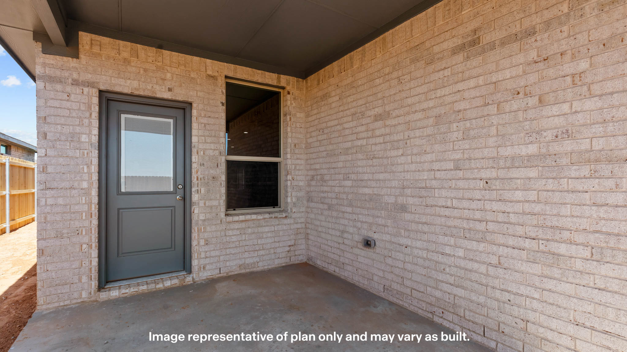 Covered back patio area overlooking spacious backyard