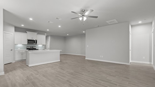Open living and family room area situated with kitchen and dining area