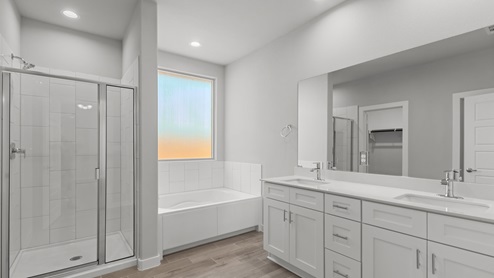 Primary bathroom with marble vanity tops