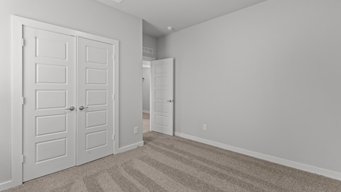 Primary bedroom with double doors leading to private bathroom