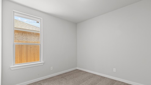 Guest bedroom with plush carpet floors