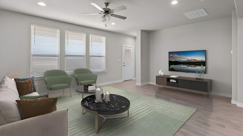 Spacious open living and family room space with plenty of natural light and accents of warm browns, greens, and golds