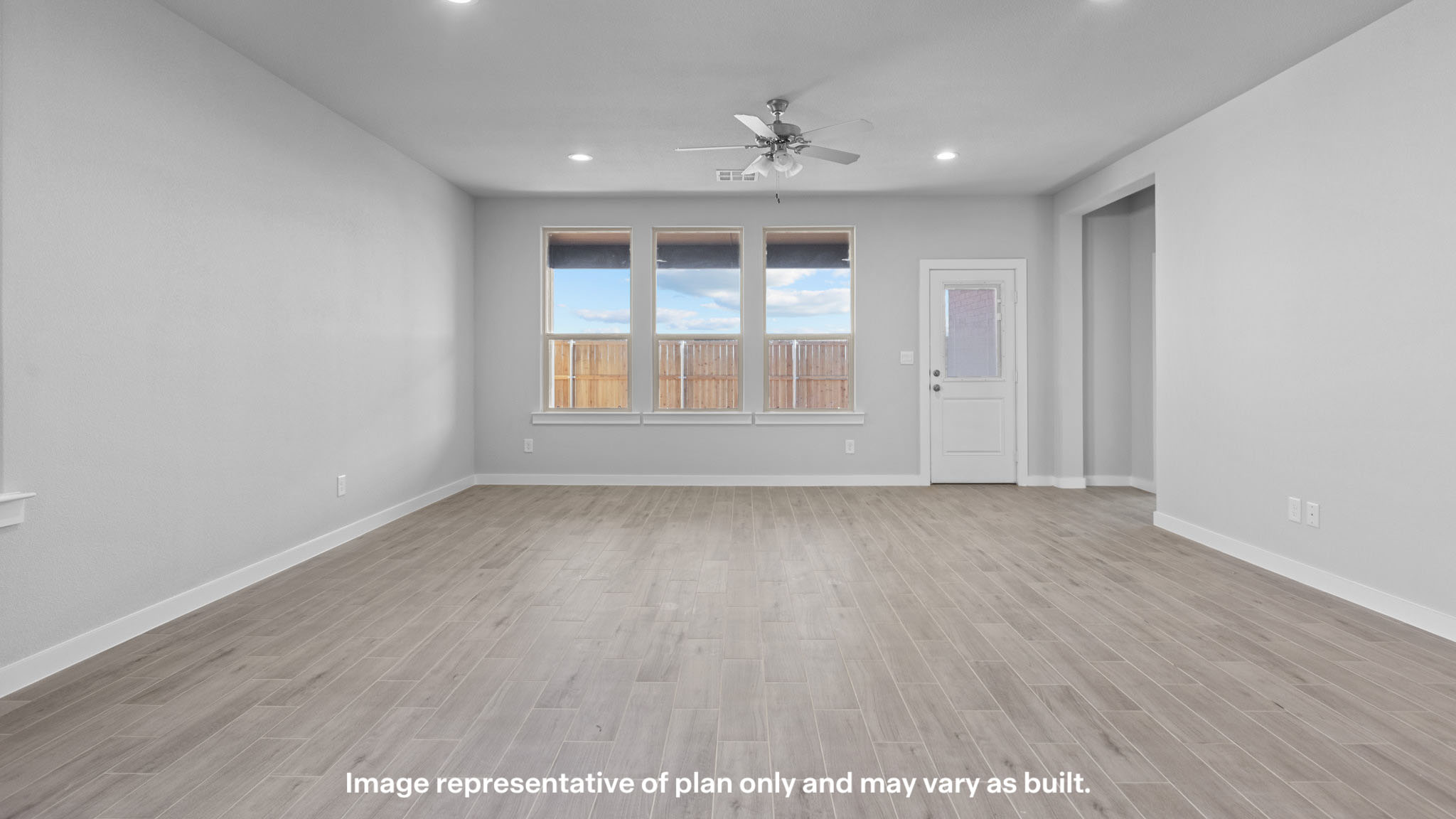 Spacious living and family room space with light allowing windows