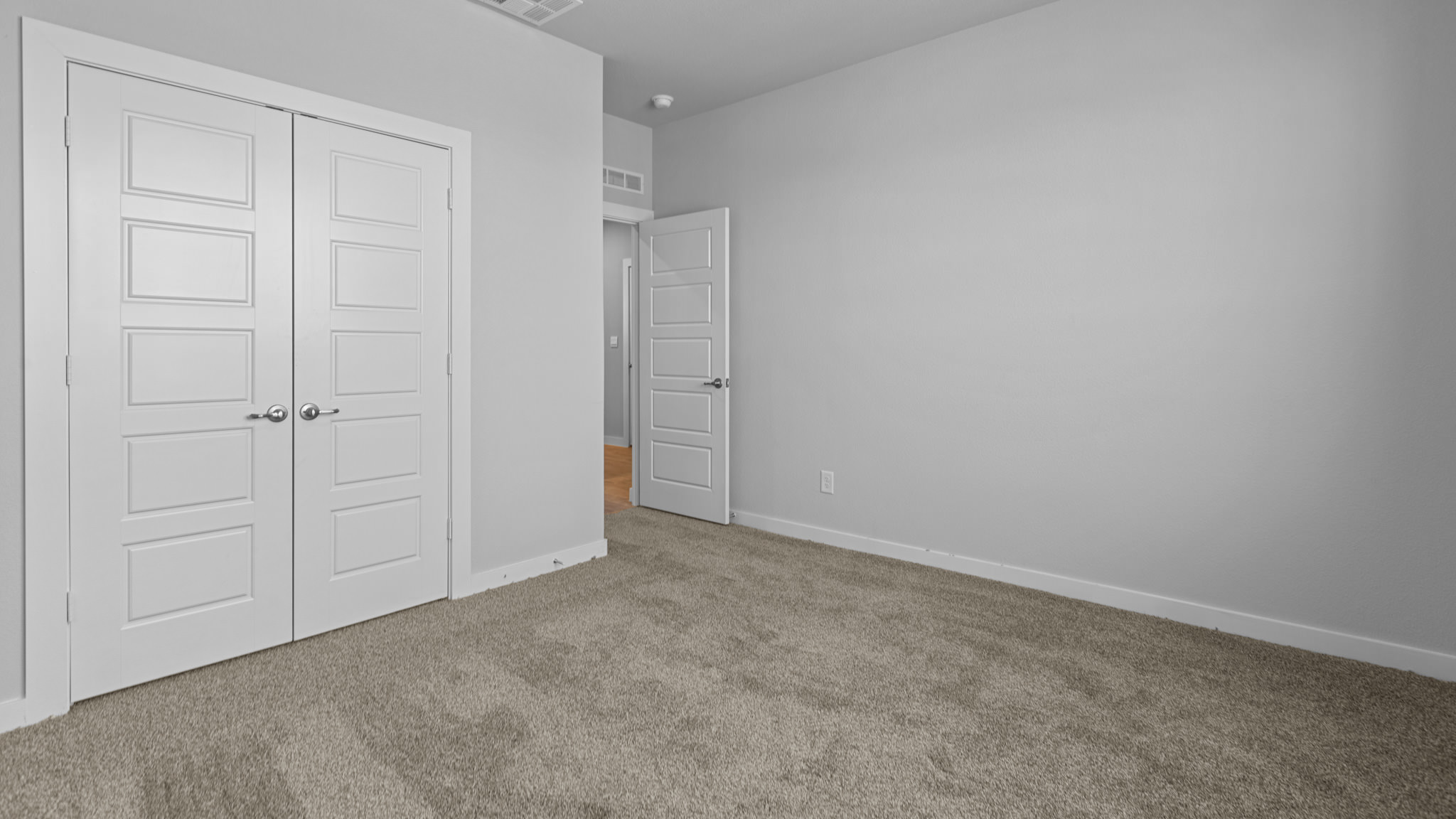 Guest bedroom 1  with front windows and ample natural light
