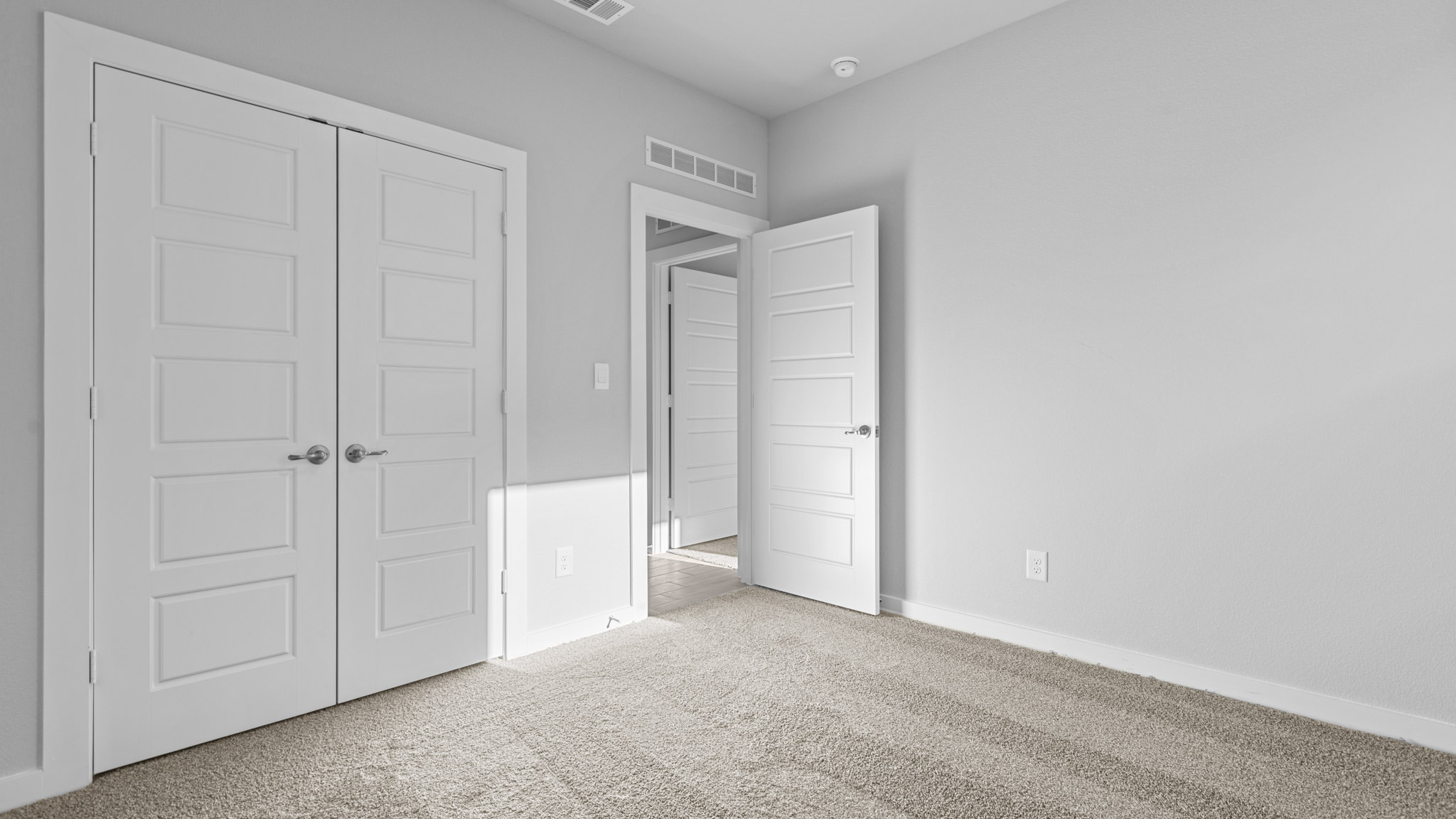 Guest bedroom 3 with plush carpet floors and spacious closet