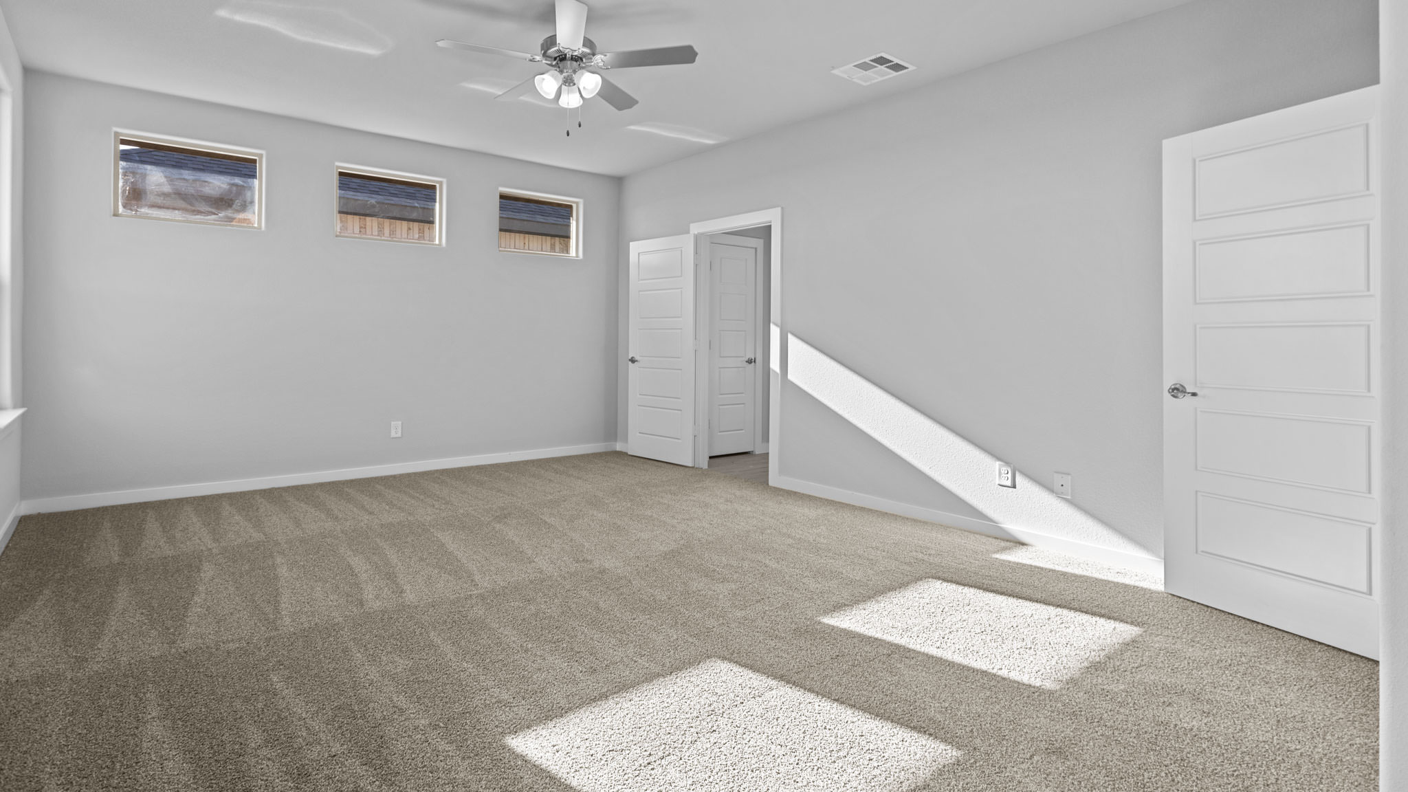 Primary bedroom with private attached bathroom and walk-in closet