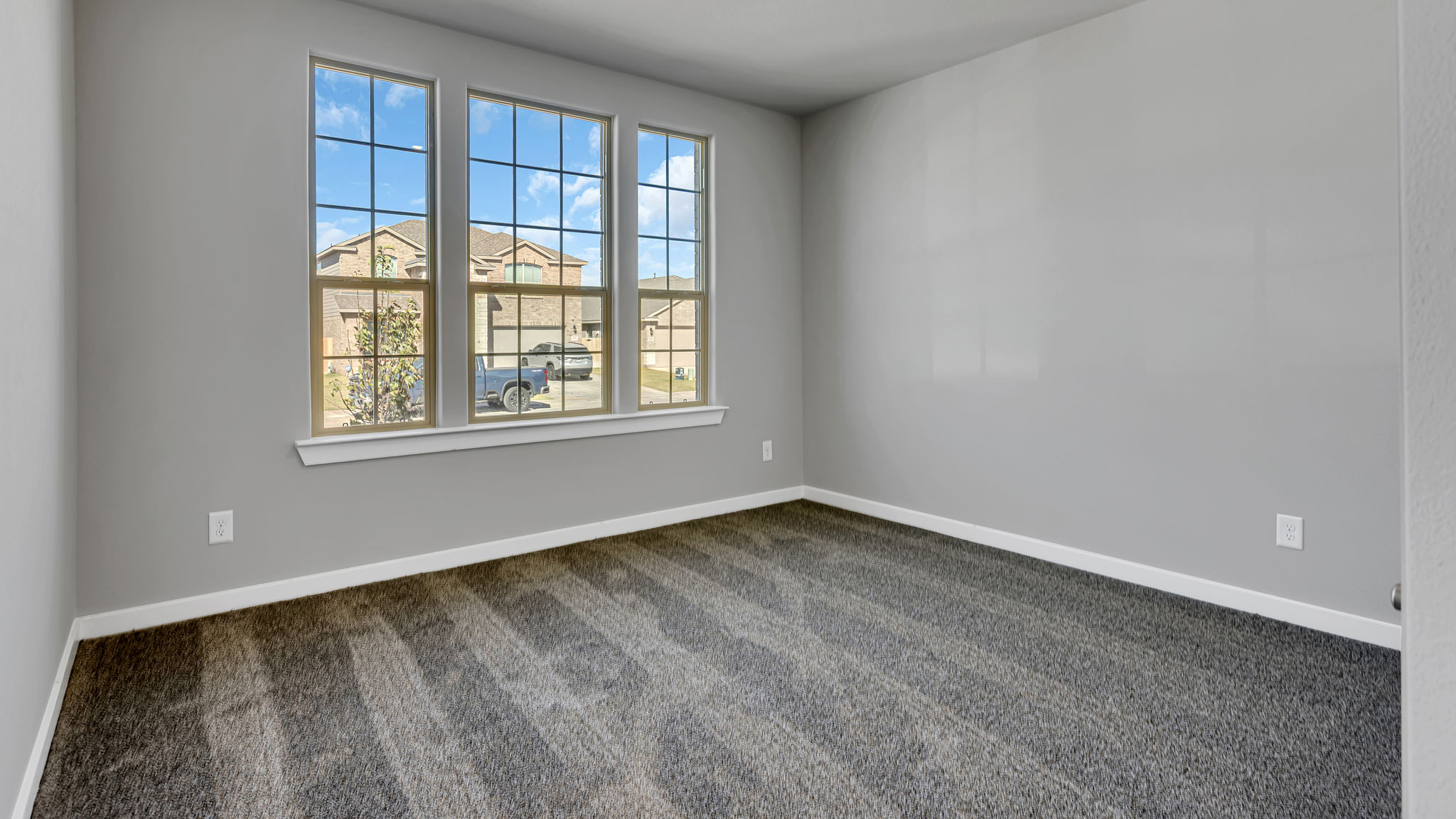 Guest bedroom 1 with front windows and ample natural light