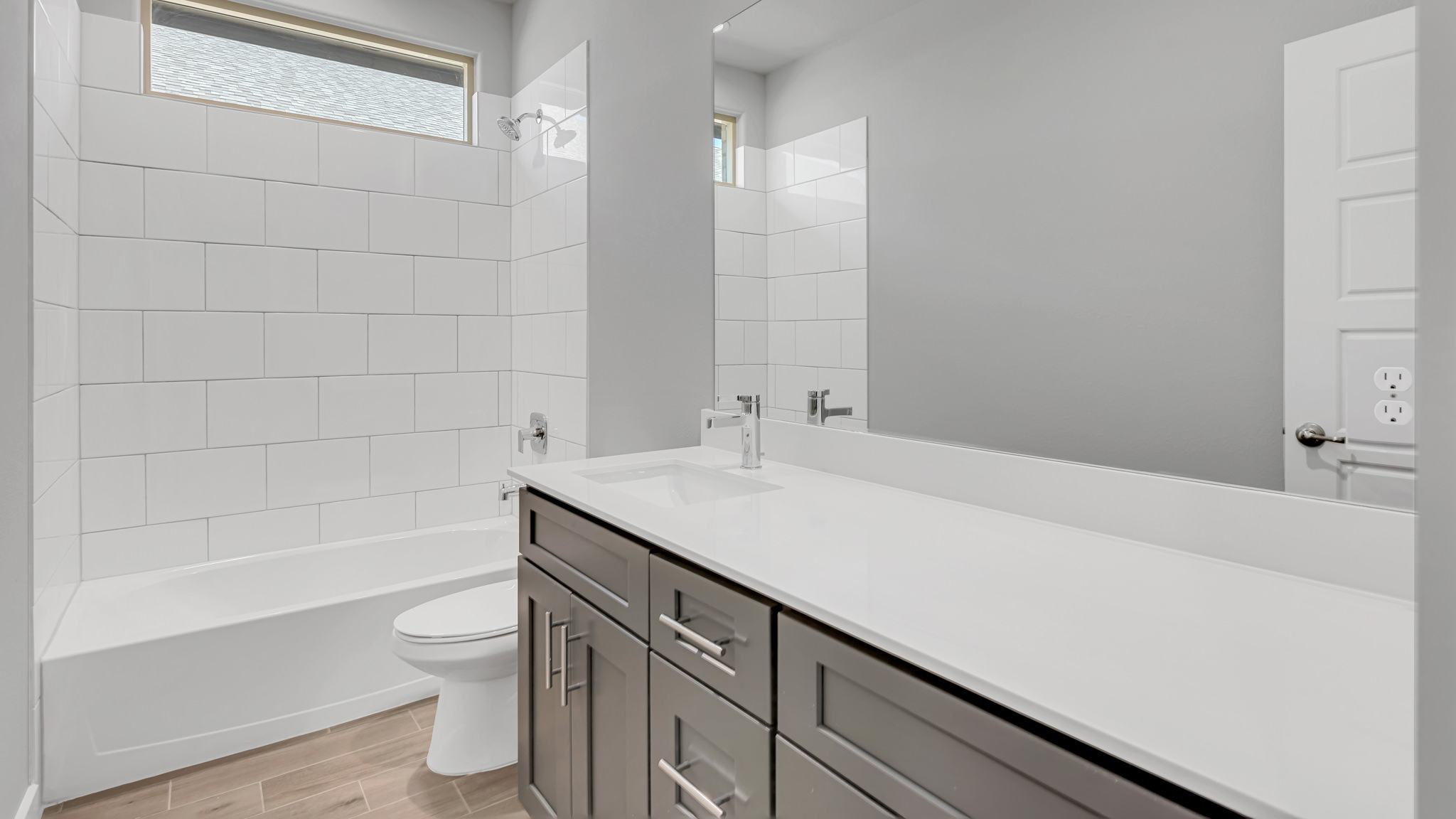 Guest bathroom with built in vanity and combination bathtub shower