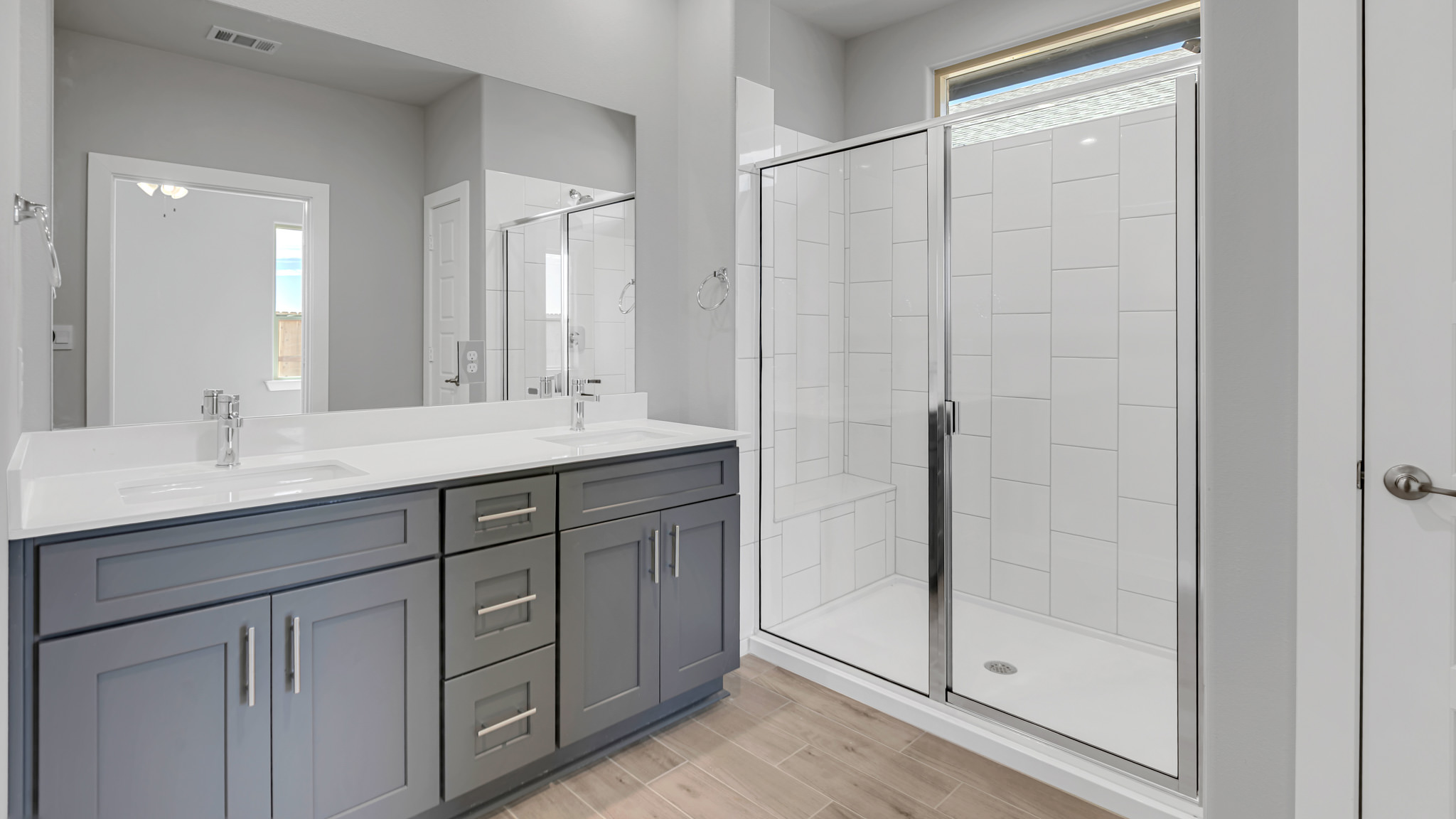 Primary bathroom with luxurious shower and built in storage