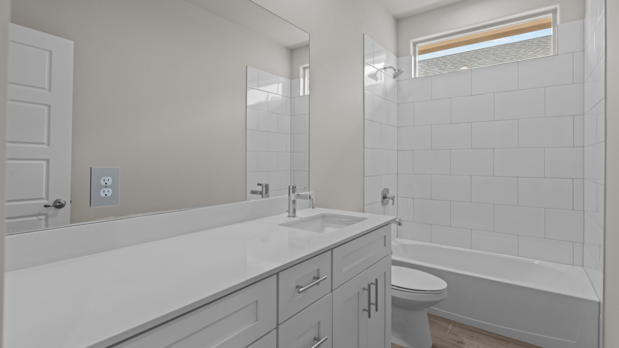 Guest bathroom with built in vanity and combination bathtub shower