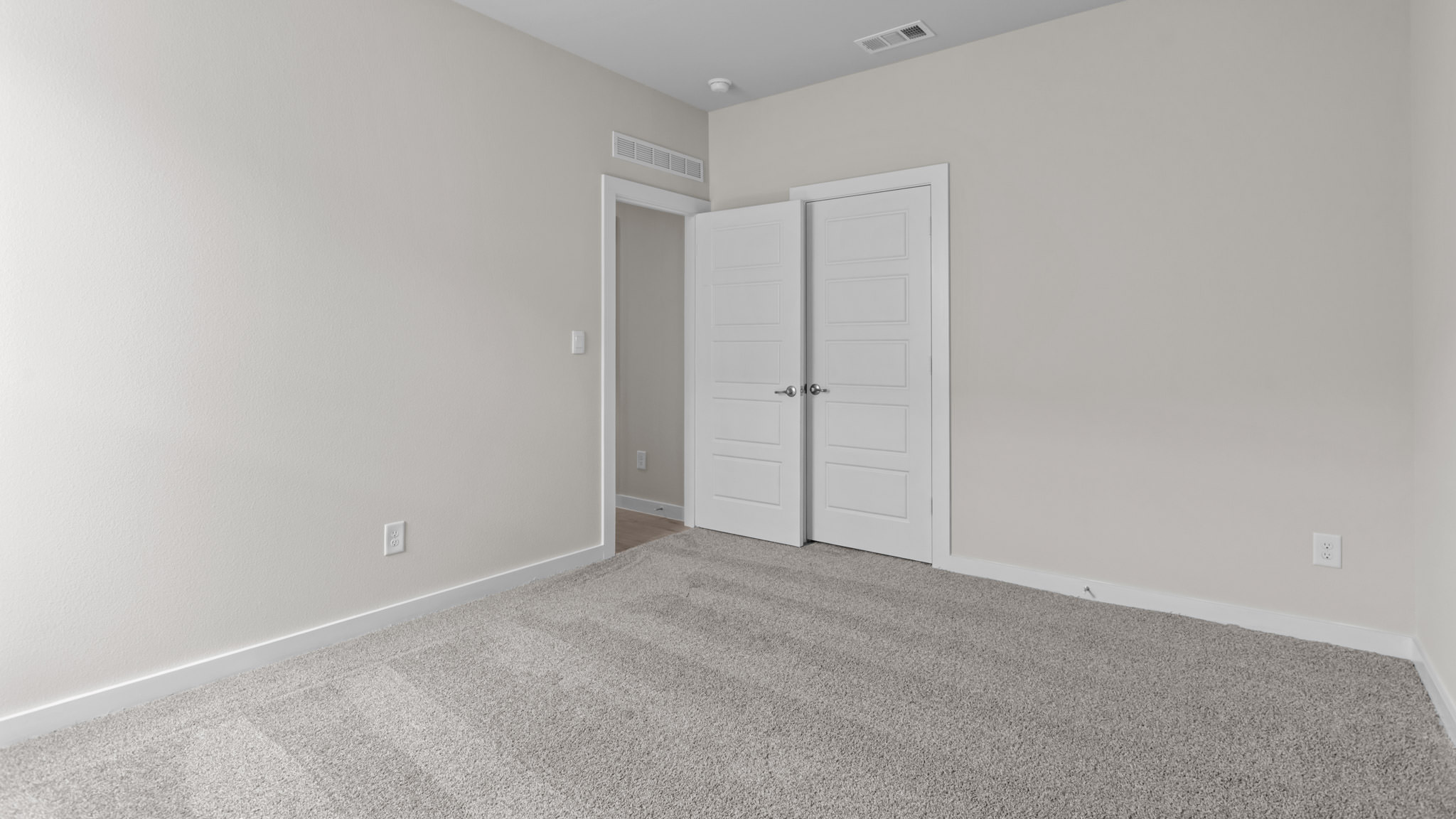 Guest bedroom 1 with front windows and ample natural light