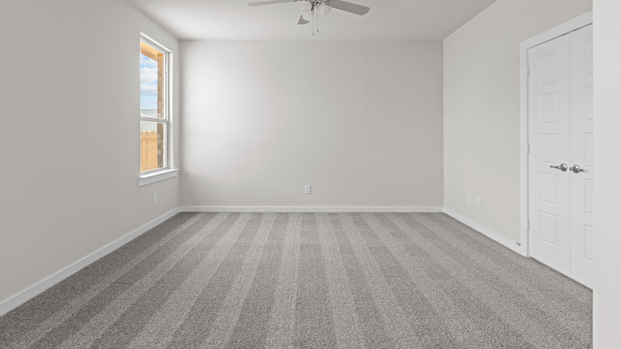Primary bedroom with plush carpet floors and light allowing double windows