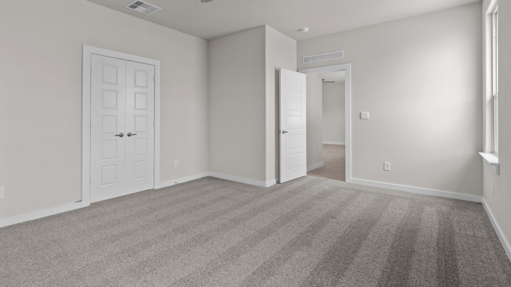 Primary bedroom with private attached bathroom and walk-in closet