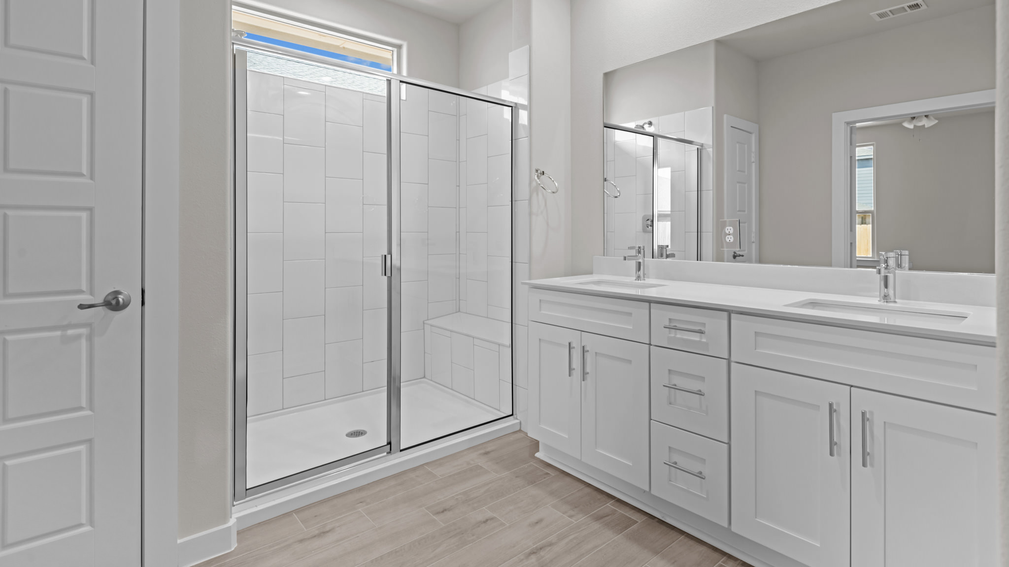 Private attached primary bathroom with built in vanity