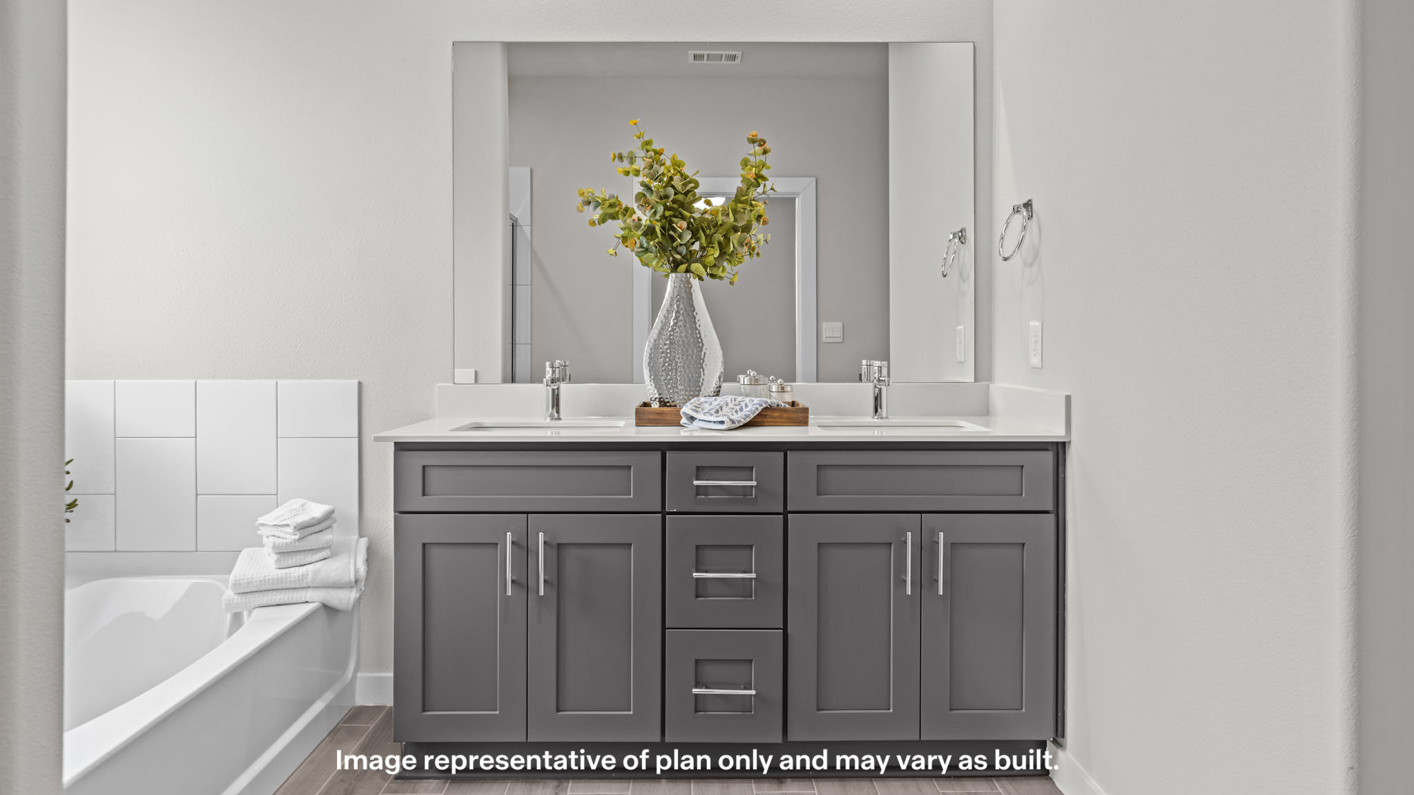Primary bathroom with dual vanities and soaking tub
