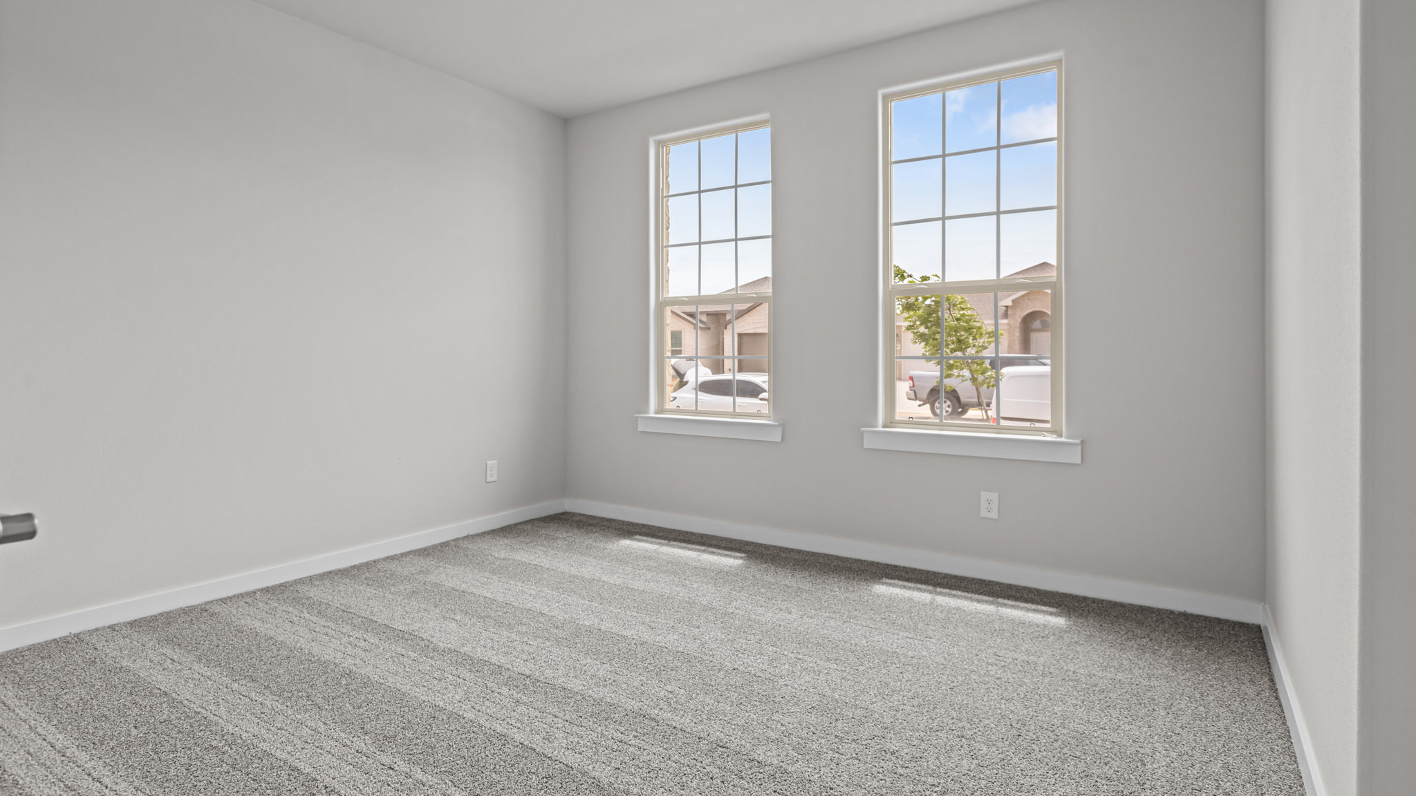 Guest bedroom 1 with front windows and ample natural light
