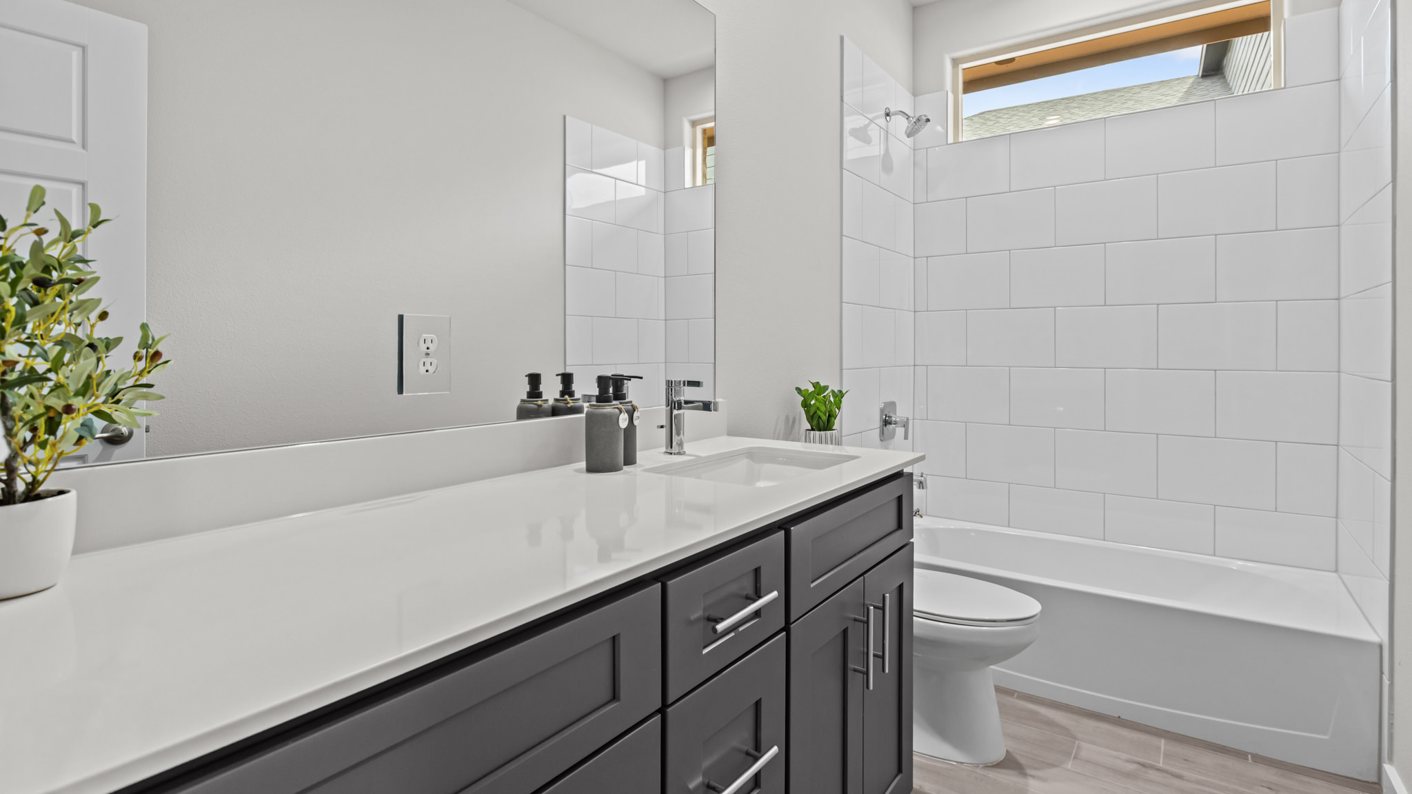 Guest bathroom with built in vanity and combination bathtub shower