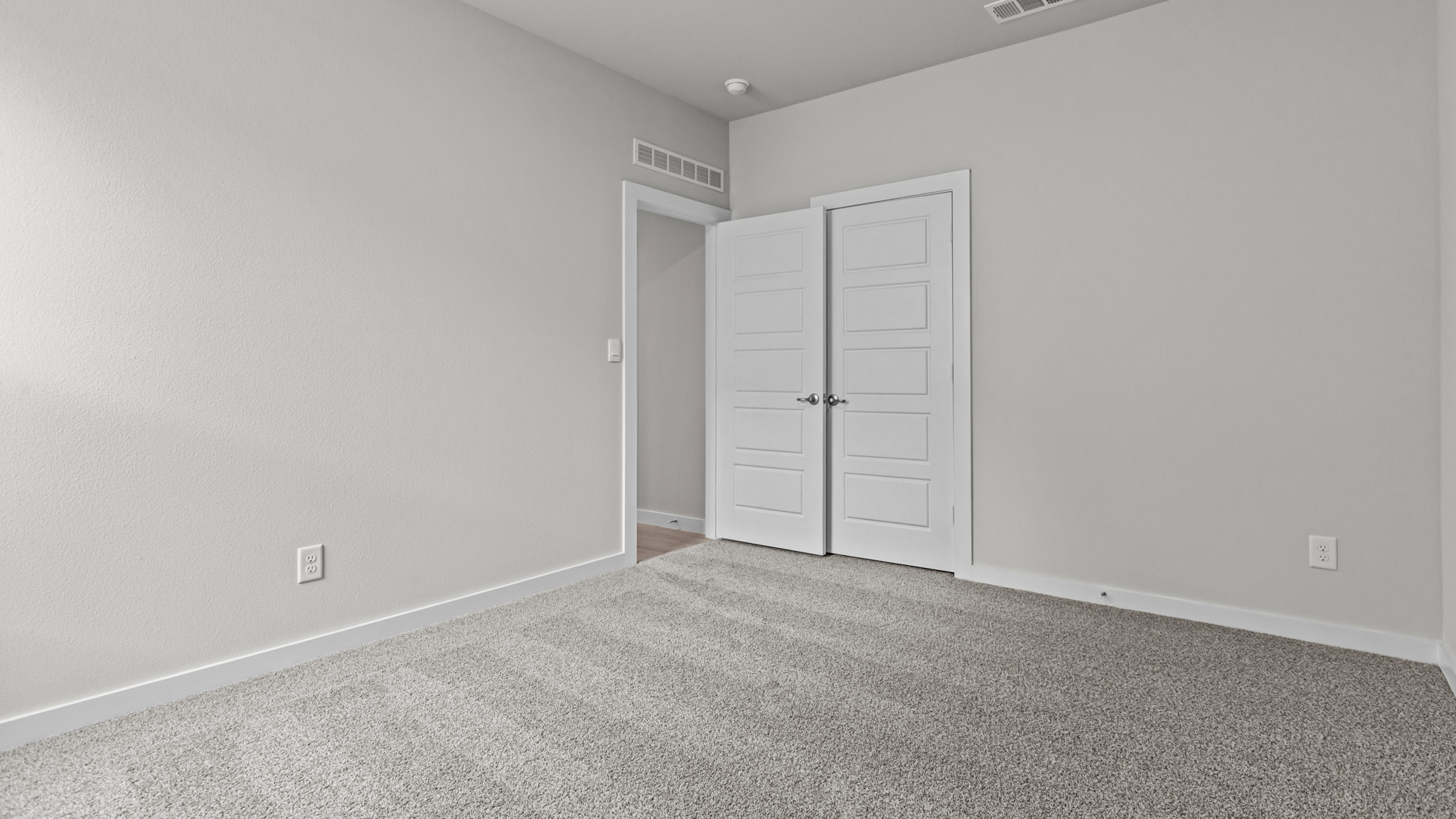 Guest bedroom 3 with plush carpet floors and spacious closet