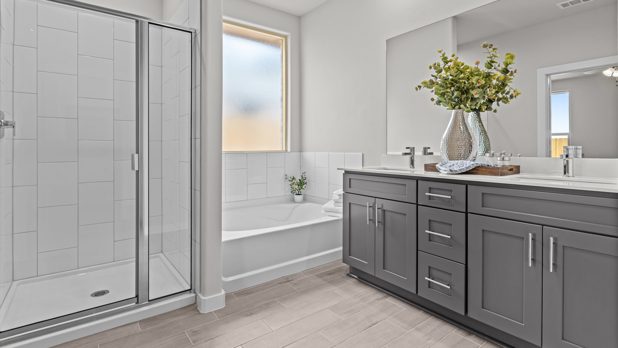 Primary bathroom with tiled shower and separate bathtub