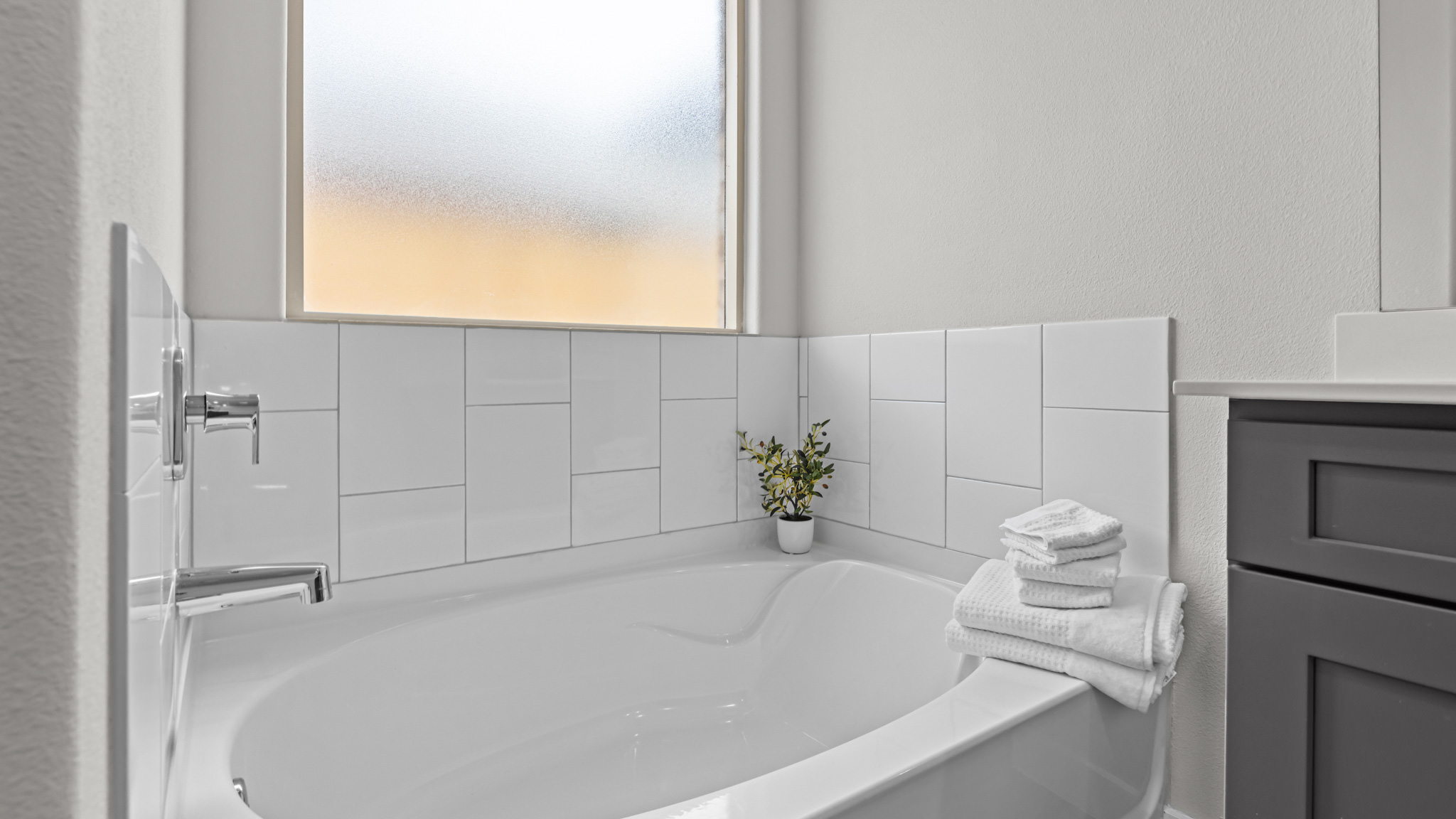 Primary bathroom with tiled shower and separate bathtub
