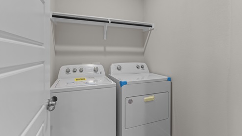 Laundry room and utility closet area with washer and dryer as well as additional storage options