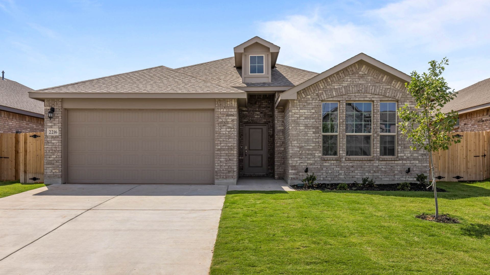Exterior of single story modern brick home with pitched roof