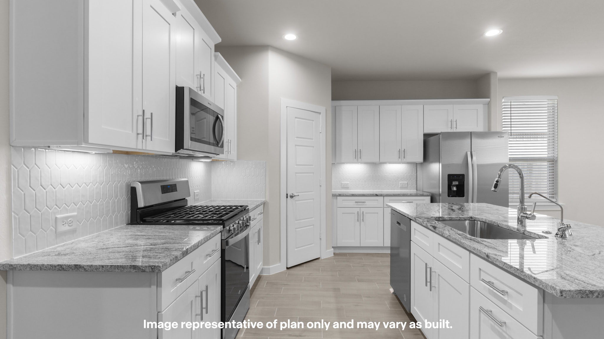 Kitchen with stainless steel appliances, shaker style cabinets, and elevated finishes