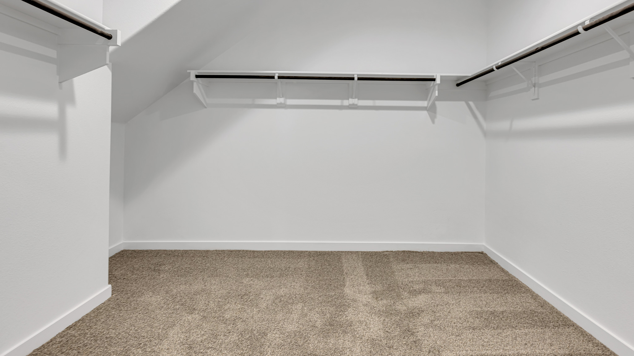 Private primary walk-in closet with extra storage space