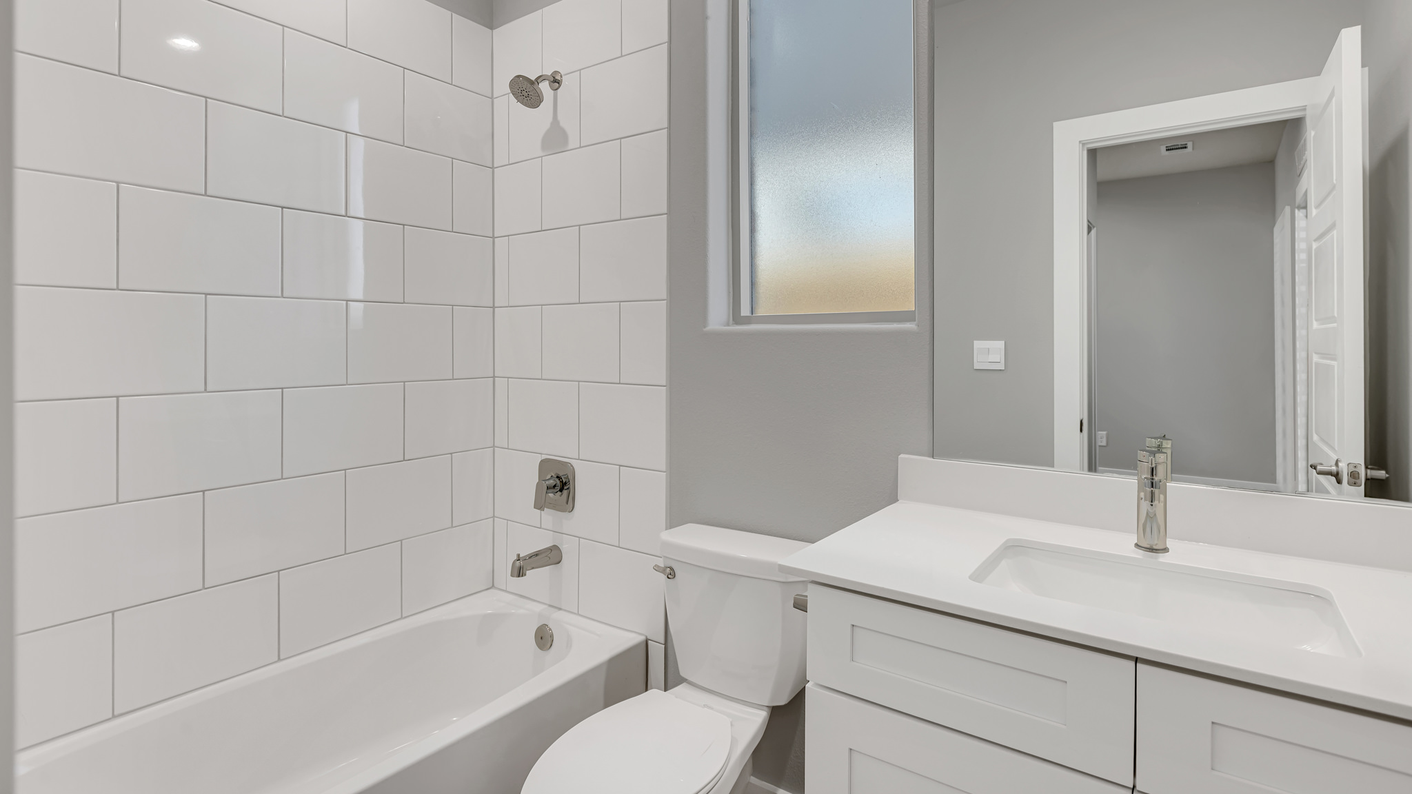 Upstairs guest bathroom with combination shower and bathtub