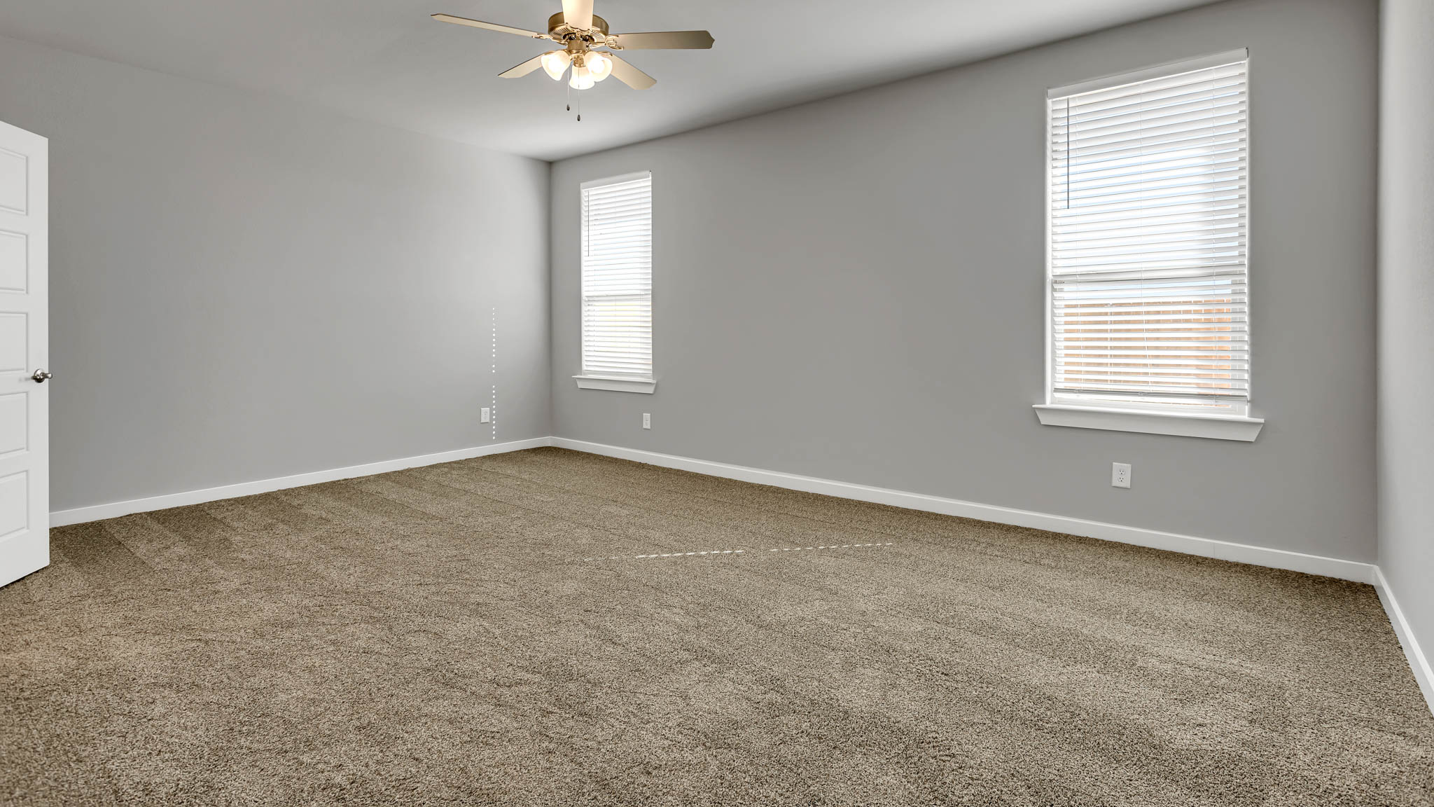 Primary bedroom with plush carpet floors and double light allowing windows