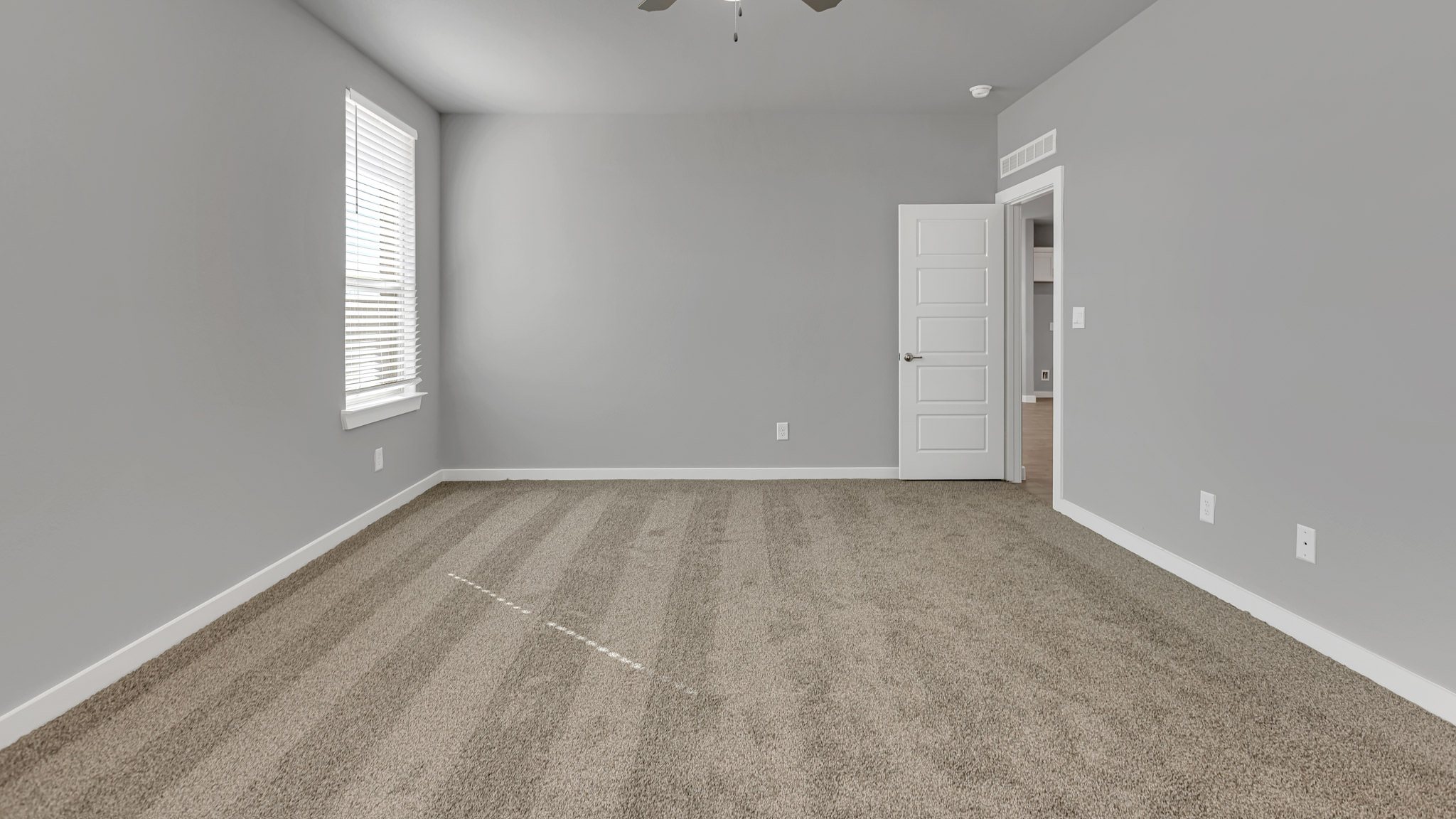 Primary bedroom with private attached bathroom and walk-in closet