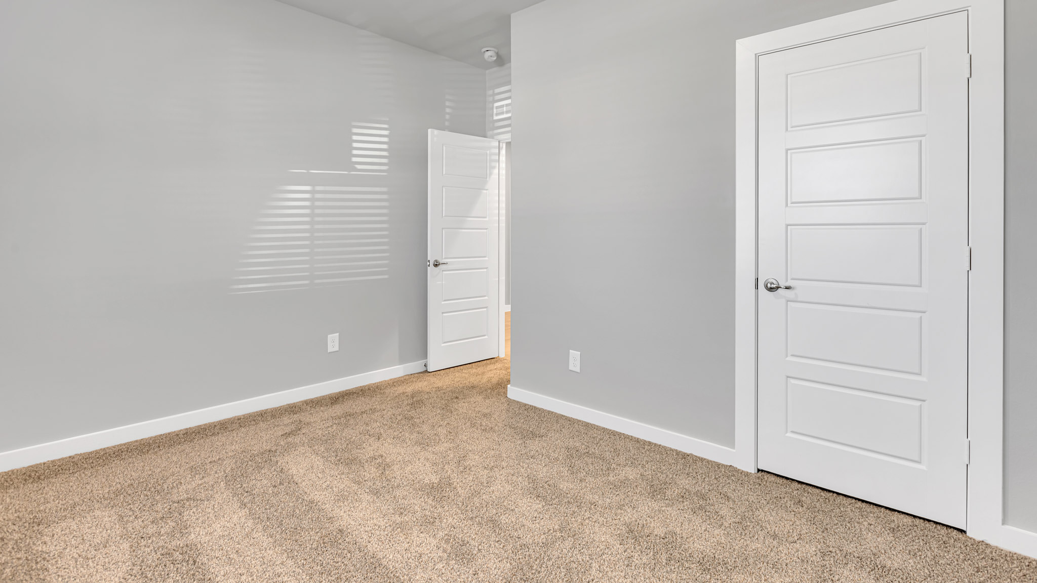 Upstairs guest bedroom 2 with plush carpet floors