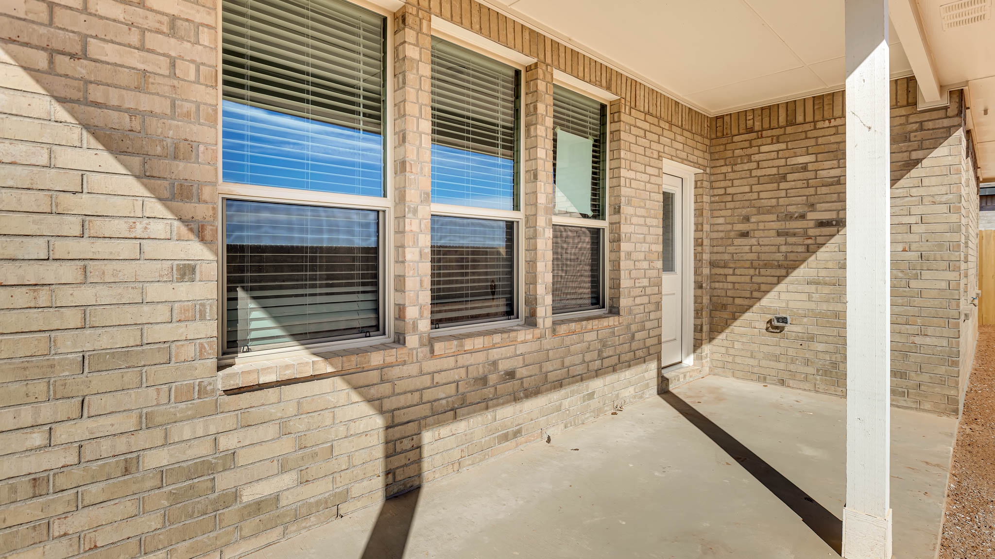 Covered back patio area overlooking private fenced-in backyard