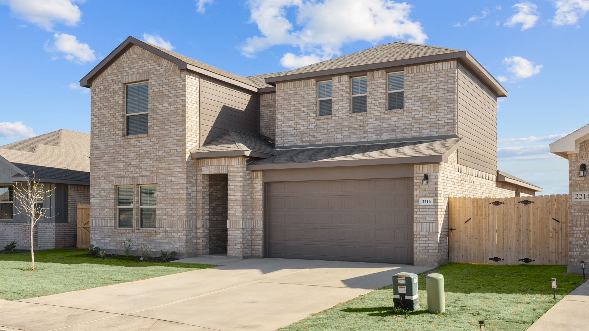 Exterior side view of classic brick home with spacious second story