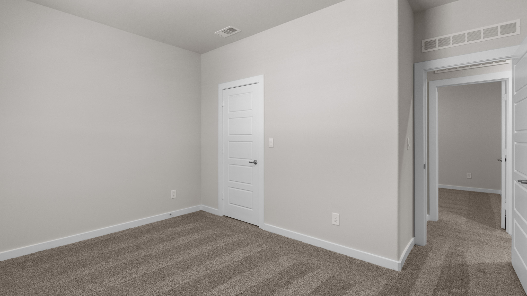 Upstairs guest bedroom with plush carpet floors