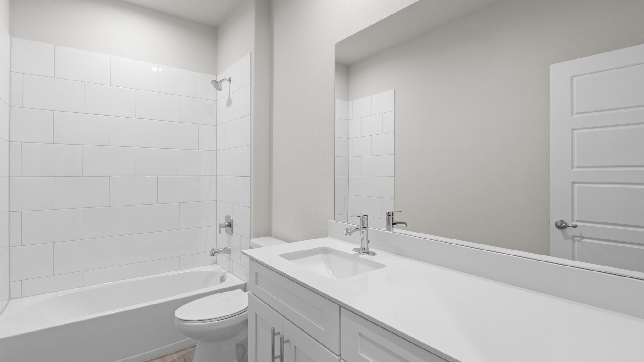 Guest bathroom with spacious vanity and tiled shower